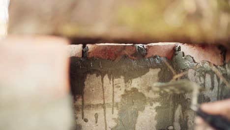 The-Man-is-Applying-Cement-to-Secure-the-Bricks-Underneath-the-DIY-Hot-Tub---Close-Up