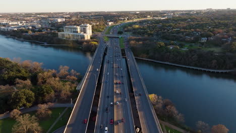 Aerial-shot-of-busy-traffic-on-highway-bridge-with-cars-commuting-and-traveling