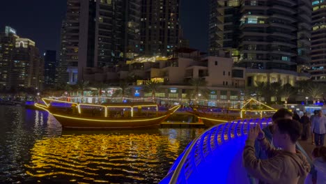 DUBAI,-UAE--04-January-2024:-tilit-shot-of-Night-view-of-Dhow-and-skyscrapers-in-Dubai-Marina---a-residential-neighborhood-and-a-district-in-Dubai,-United-Arab-Emirates