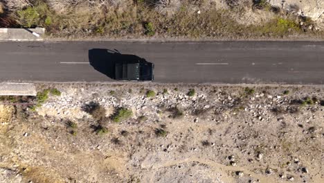 Drone-tracking-shot-of-a-car-on-a-road-in-the-south-of-France,-aerial-view