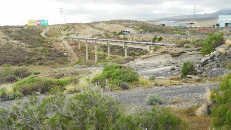 Landscape-of-Arco-de-Tajao-in-Tenerife-with-pipeline-and-highway,-panoramic