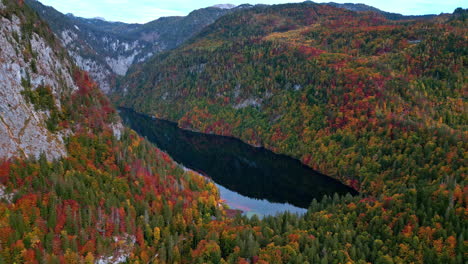 Lake-Toplitz-in-mountain-valley-with-colorful-autumn-forest-all-around