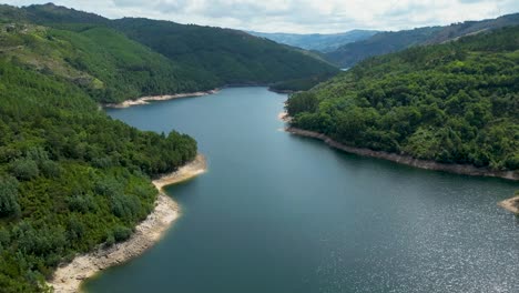 Dam-aerial-shot-in-northern-Portugal,-Salamonde,-Montalegre,-Portugal,-aerial-shot-on-a-sunny-day-geres-national-park,-calm-lake