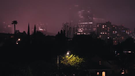 Rainy-Night-in-Los-Angeles,-California-USA,Moody-Weather,-Street-Lights-and-Skyscrapers-in-Mist