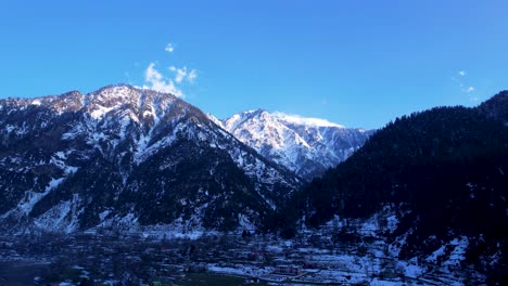 Snow-capped-mountains-under-blue-sky-at-Athmuqam,-Neelum-Valley,-Azad-Kashmir