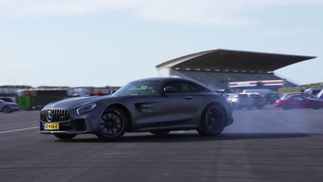 Horse-power,-luxury-sports-car-drifting-on-asphalt-creating-smoke-from-wheels