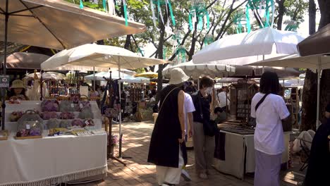 People-walking-around-handicraft-market-in-Chiang-Mai,-Thailand