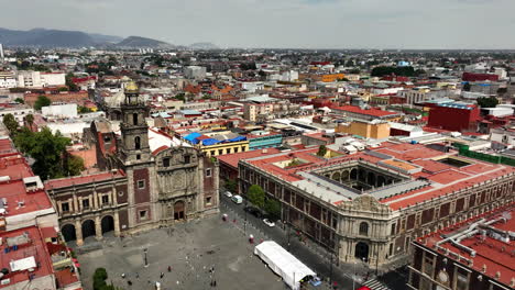 Drone-passing-the-Santo-Domingo-Square-over-colorful-buildings-of-Mexico-city