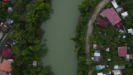 Aerial-Top-View-of-Turquoise-loboc-river-in-Philippines-Tropical-Jungle-Village-Southeast-Asian-Green-Landscape-in-Wet-Weather