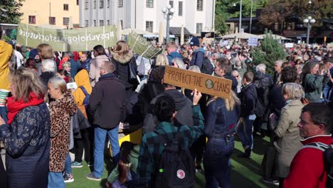 Climate-protest-rally-in-Stockholm,-Sweden,-"Protect-the-oceans"-sign-visible