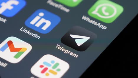 Close-up-of-a-smartphone-screen-showing-app-icons-with-a-focus-on-Telegram-icon