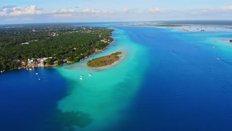 Beautiful-Scenic-Views-Overlooking-Bacalar-and-Turquoise-Waters-at-Laguna-De-Los-7-Colores-in-Mexico,-from-an-Aerial-Drone
