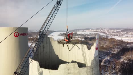 Demolition-Excavator-Lifted-By-Crane,-Dismantling-Cooling-Tower-Of-Fossil-Fuel-Power-Station-In-Czech-Republic