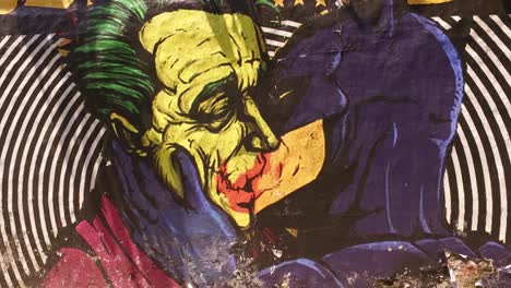 Batman-Kissing-Joker-Graffiti,-LGBT-Inspired-Street-Artwork,-Sao-Paulo,-Brazil,-Close-Up-Tilt-Down