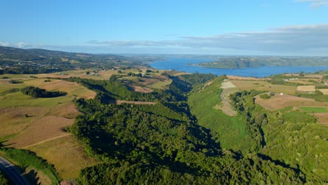 Aerial-panoramic-landscape-of-Chiloe,-Lemuy-island-green-fields-in-chilean-patagonia-drone-skyline,-blue-morning-in-south-america,-daylight