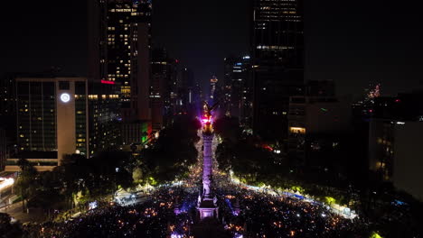 Aerial-view-over-the-Angel-of-Independence,-New-Years-fireworks,-night-in-Mexico-city