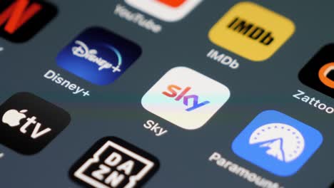 Swiping-Smartphone-and-stop-at-Sky,-Dazn-and-Disney-apps