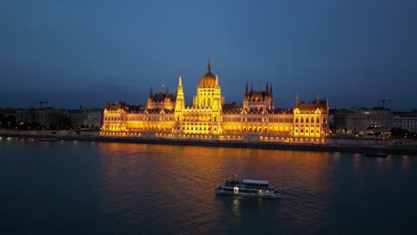 Boat-Tour-at-Danube-River-along-Parliament-Building-in-Budapest,-Hungary---Aerial-4k