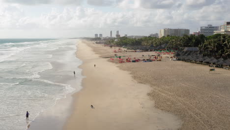 Aerial-view-of-the-beach,-palm-trees-and-the-city-around,-Praia-do-Futuro,-Ceara,-Brazil