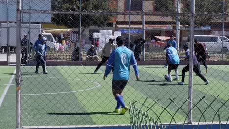 Fun-neighborhood-game-of-soccer-on-football-field-in-Sucre,-Bolivia