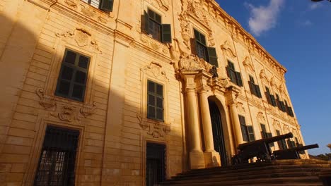 Malta,-Castille-palace-and-the-street-lights-with-two-flags,-Maltese-and-European-union,-fluttering-on-the-wind