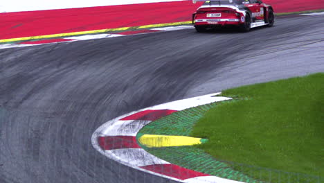 Audi-car-racing-through-a-tight-turn,-Red-Bull-Ring-Austria