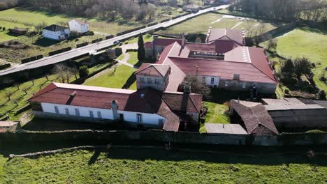 Drone-left-to-right-orbit-around-roof-top-establishing-San-Salvador-de-Ferreira-monastery