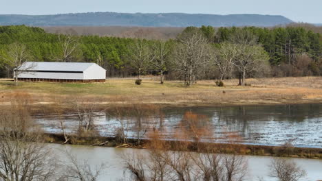 Tranquil-scene-of-Point-Remove-Wildlife-Area,-Blackwell,-Arkansas-with-barn,-water,-and-trees