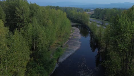 Aerial-Perspective-of-Bulkley-River-Flowing-Beside-Yellowhead-Highway-near-Houston,-Northwood-Picnic-Site,-with-Bridge-in-View