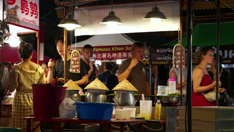 Extranjeros-Buscando-Comida-En-El-Mercado-Nocturno-Local-En-Tailandia