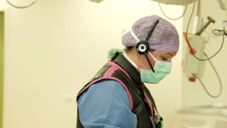 Doctor-preparing-for-operating-on-patient-opening-a-pack-of-sterile-gloves