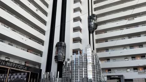 Futuristic-looking-elevators-going-up-and-down-in-the-atrium-of-the-Crown-Casino,-Perth,-Western-Australia