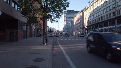 Slomo-pan-from-cars-on-street-to-spot-where-Palme-was-shot,-Stockholm