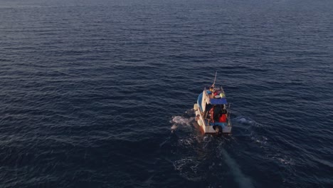 Aerial-view-of-fishing-boat-on-Mediterranean-Sea-at-sunset,-Sicily,-Italy