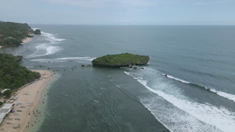 Aerial-drone-shot-of-shoreline-and-huge-coral-island