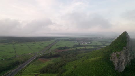 Misty-aerial-view-of-Verdun,-Mauritius-with-lush-landscapes-and-winding-roads,-early-morning
