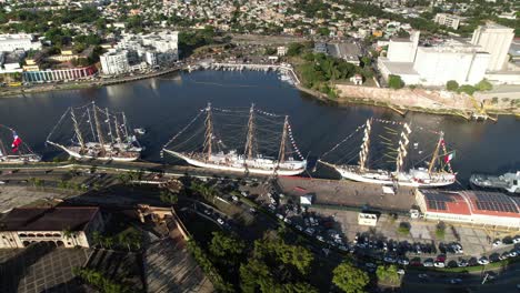 Orbit-View-over-Meeting-of-Army-School-Vessels-in-Santo-Domingo-City,-Ozama-River