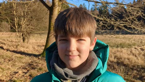 Cute-Boy-Smiling-in-a-Danish-Forest,-Portrait-of-Kid