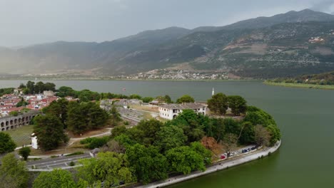 Sunset-behind-the-mountain-and-old-town-Ioannina-on-the-Lake-Pamvotida-in-Greece,-aerial