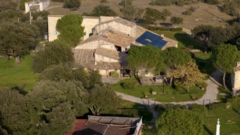 Aerial-view-of-scenic-traditional-farm-house-mansion-with-solar-panels-in-southern-France