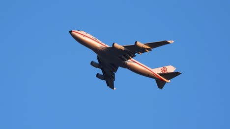 Red-Striped-Cargolux-B747-Passenger-Plane-Flying-Overhead,-No-Clouds