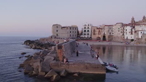 Aerial-view-of-Cefalu-medieval-city-during-summer-at-sunset,-Sicily,-Italy