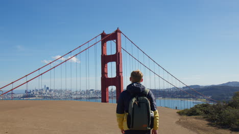 Man-Walking-At-Viewpoint-With-View-Of-Golden-Gate-Bridge-Tower-In-San-Francisco,-California