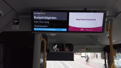 Coronavirus-info-in-English-on-screen-in-bus-in-Stockholm,-Sweden