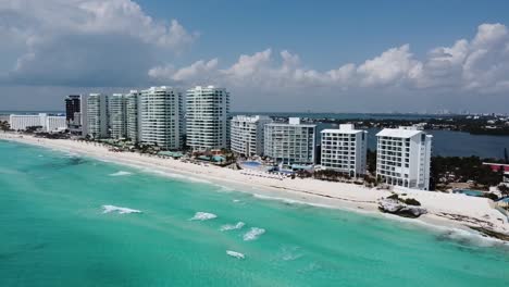 Cancun-coastline-with-turquoise-waters-and-white-buildings,-aerial-view