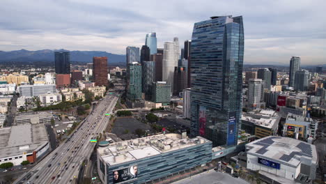 Los-Angeles-USA,-Aerial-View-of-California-110-State-Route-Highway-Traffic,-Harbor-Freeway,-JW-Marriott-Hotel,-Peacock-Theater-and-Financial-District-Towers