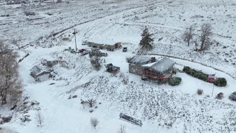 Drone-shot-of-snow-falling-on-rural-Washington-house,-Benton-City
