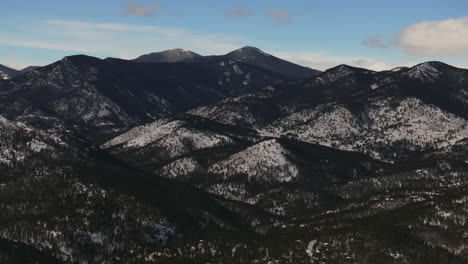 Evergreen-Colorado-Old-Squaw-Pass-Denver-Open-Space-aerial-drone-cinematic-fresh-snow-dusting-cold-white-scenic-landscape-toward-traffic-driving-front-range-sunset-bluesky-circle-left-motion