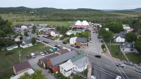 People-gathered-at-the-annual-Polka-fest-in-Cedar-Michigan,-USA,-Aerial-forwarding-shot