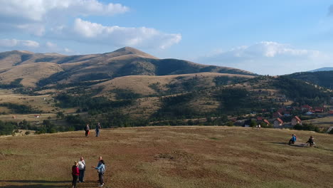 Tourists-visiting-Monument-To-The-Executed-Partisans-Of-Zlatibor,-Serbia-Aerial-wide-shot-revealing-beautiful-mountain-landscape